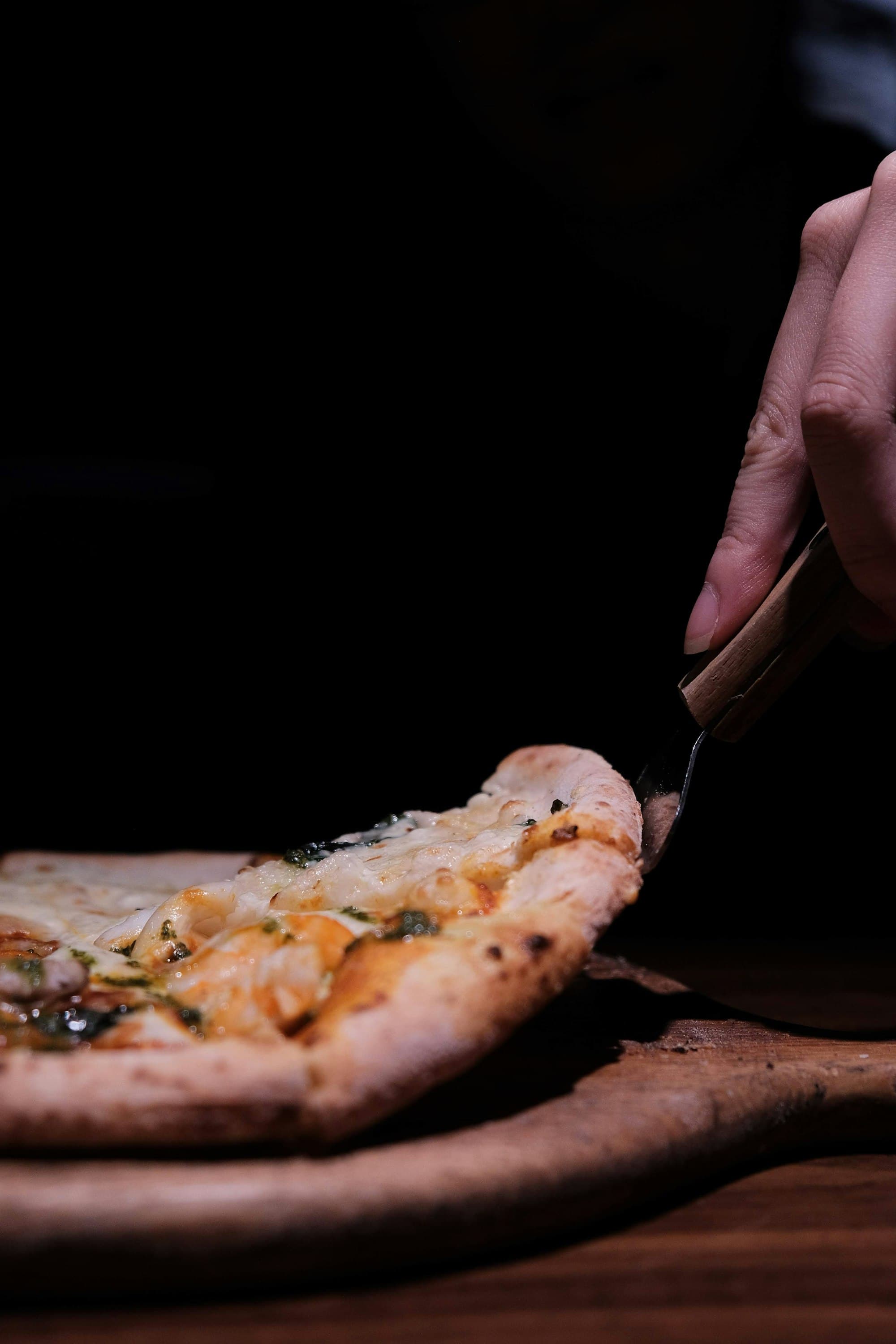 Fresh pizza being sliced at Love Letter